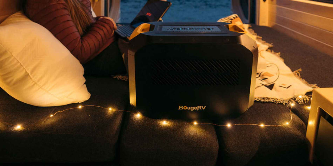 A girl using BouRV’s portable power station in the car during camping
