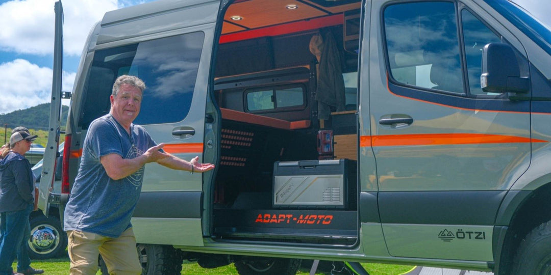 A man showing BougeRV's newest Rocky fridge that's sitting in the car